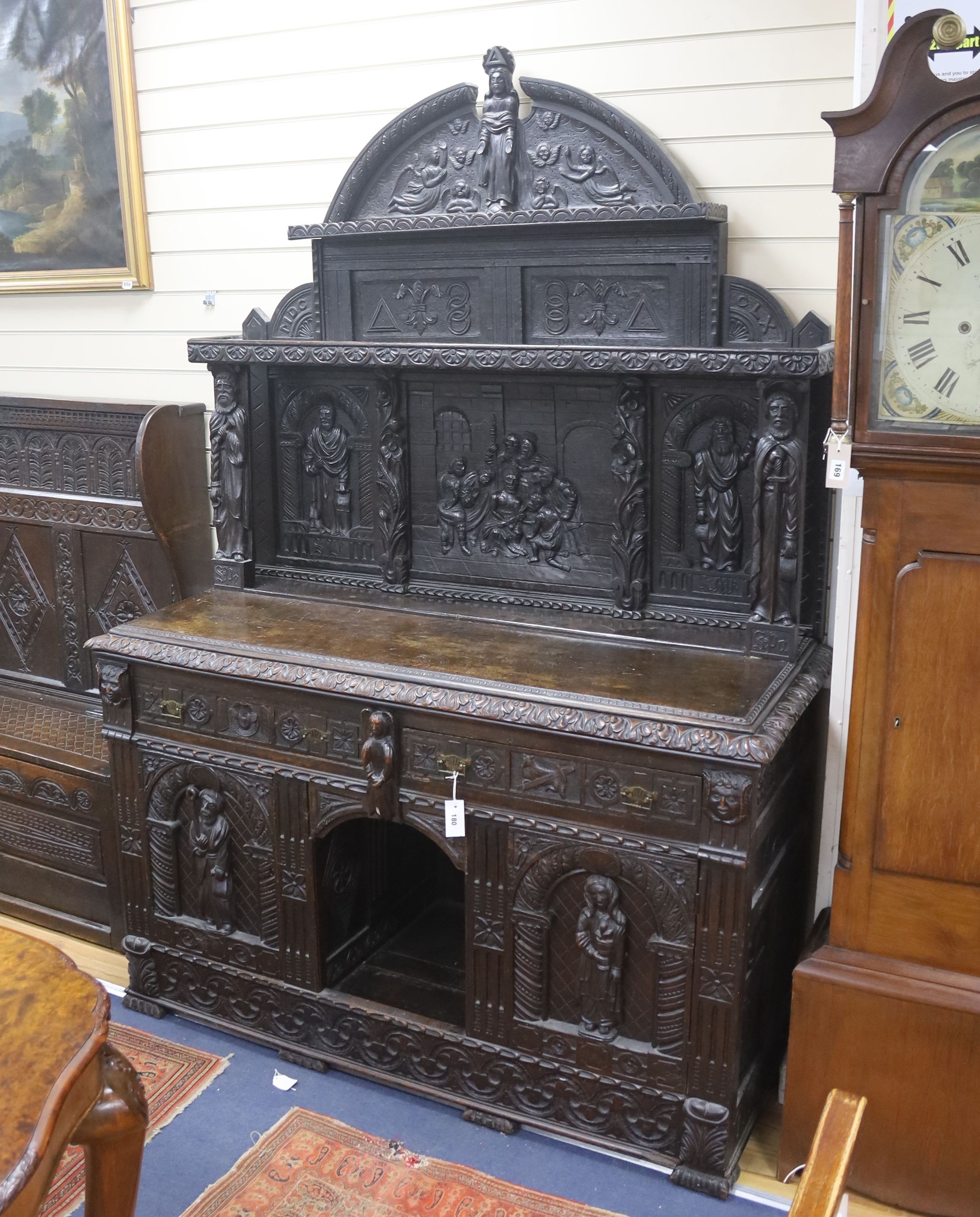 A late 19th century Flemish carved oak sideboard with raised panelled back, width 150, depth 60, height 215 cms.